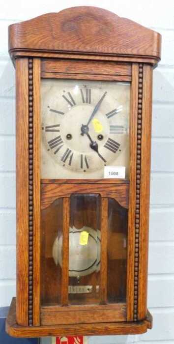 An oak cased wall clock, with Roman numeric dial and eight day movement. (AF)