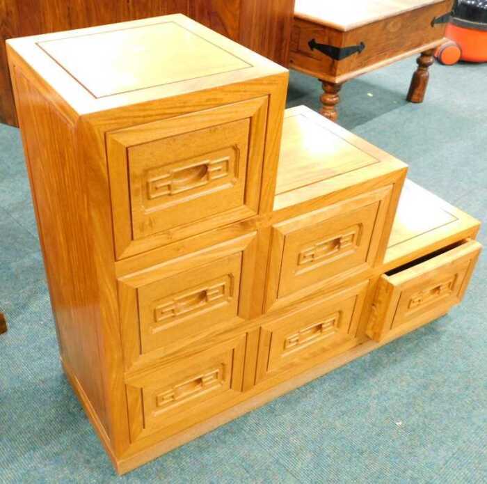A 20thC hardwood stepped cabinet, set with six drawers.