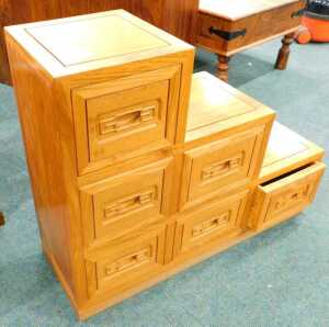 A 20thC hardwood stepped cabinet, set with six drawers.