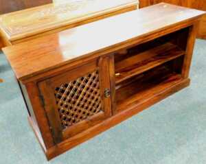 A Jig hardwood television stand, of rectangular form with mesh front cupboard and open shelves.