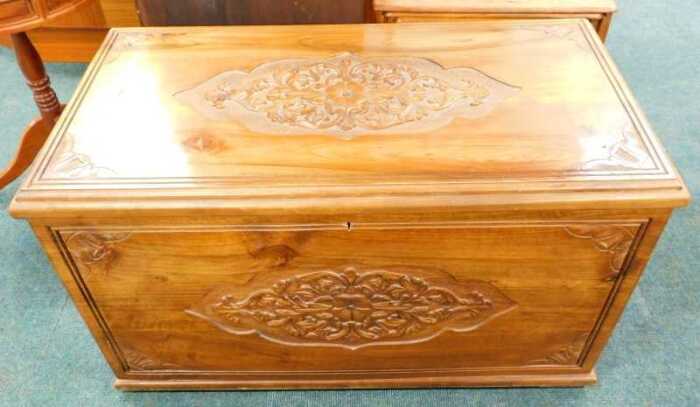 A 20thC camphorwood chest, of rectangular form, heavily carved with a candle box interior, with...