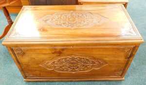 A 20thC camphorwood chest, of rectangular form, heavily carved with a candle box interior, with...