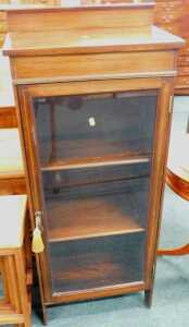 An Edwardian mahogany cabinet, of rectangular form with plain glazed front.