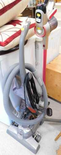 An upright Wand Powersonic lithium power 26.16 volt vacuum cleaner, in pink and silver trim, and...