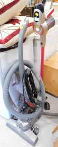 An upright Wand Powersonic lithium power 26.16 volt vacuum cleaner, in pink and silver trim, and...
