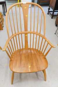 An Ercol light wood Windsor style chair.
