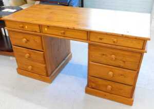 A pine twin pedestal desk, with three drawers to each pedestal.