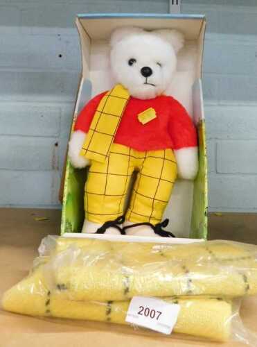 A plush jointed Rupert toy, partially boxed, with scarf.