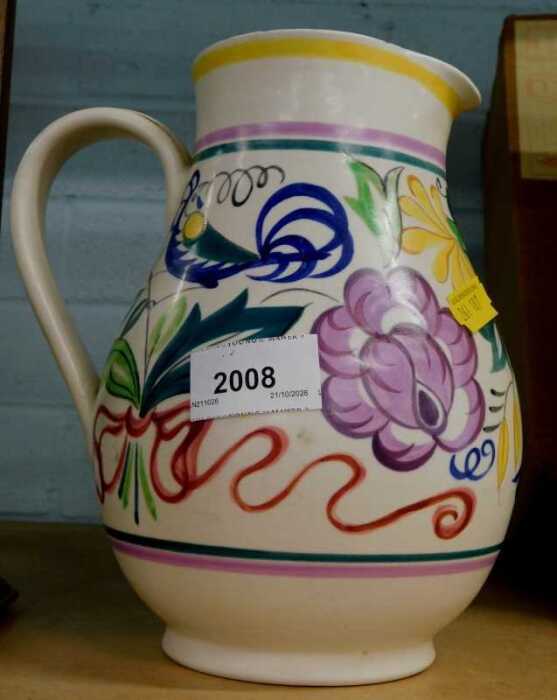 A Poole pottery jug, profusely decorated with flowers.