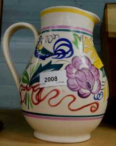 A Poole pottery jug, profusely decorated with flowers.