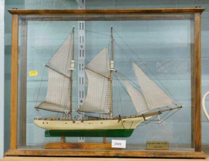 A model of the Goleta Dos Palos ship, with realistic rigging and deck, in glazed case.