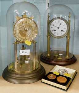 An anniversary clock, another similar, and a Mary Rose reproduction compass.