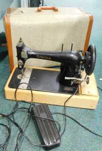 A cased electric sewing machine.