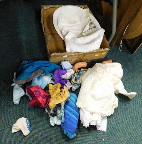 Various items of dolls clothing and a doll. (1 box)