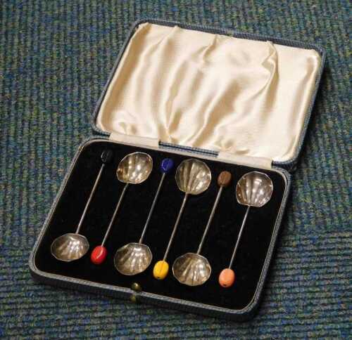A cased set of coffee bean spoons.