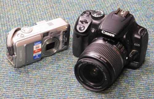 A Canon Zoom lens EF-S 18-55mm camera, with 1:3.5-5.6 lens, and a further Canon digital camera. (2)