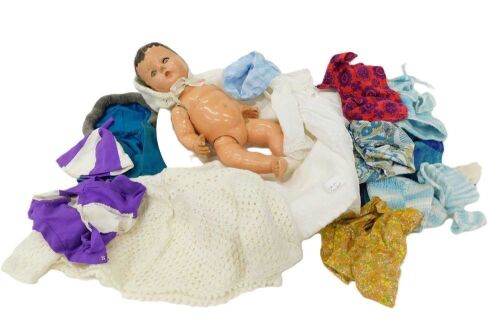 Various items of dolls clothing and a doll. (1 box)