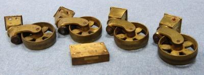 *Four 19thC cast brass castors and a lock.
