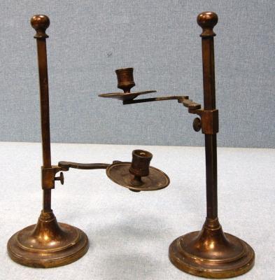 *A pair of late 19thC adjustable metal candlesticks