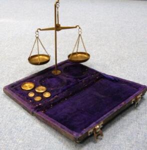 *A set of brass pocket scales with weights