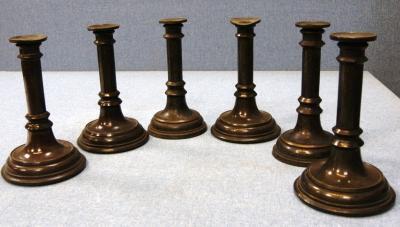 *A set of six late 19thC turned metal candlesticks