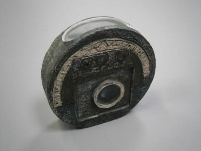 A circular slab vase