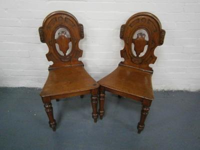 A pair of Victorian oak hall chairs