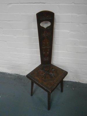 A carved and poker work oak spinning stool.