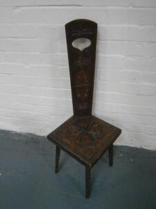 A carved and poker work oak spinning stool.