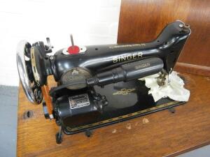 A Singer oak cased treadle sewing machine. - 2