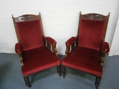 A pair of late Victorian walnut arm chairs