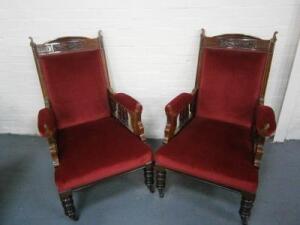 A pair of late Victorian walnut arm chairs
