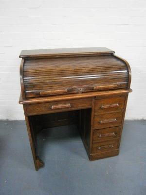 An Edwardian oak roll top desk