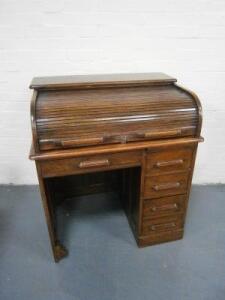 An Edwardian oak roll top desk