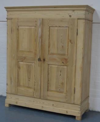 A stripped pine two door armoire