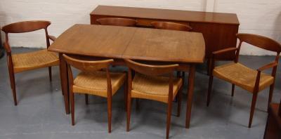 A Danish Control teak extending dining table and six rattan seated chairs