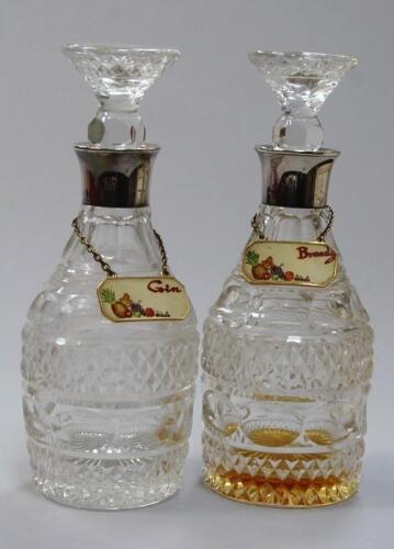 A pair of cut glass mallet shaped decanters and stoppers