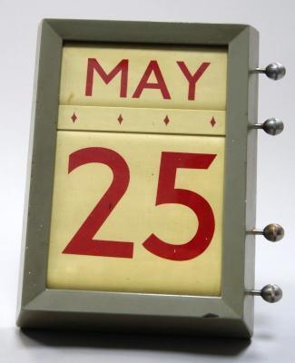 *A wall mounted perpetual office calendar.