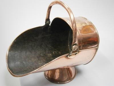 A copper coal scuttle.