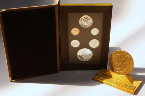 Five mounted Money For Food coin sets