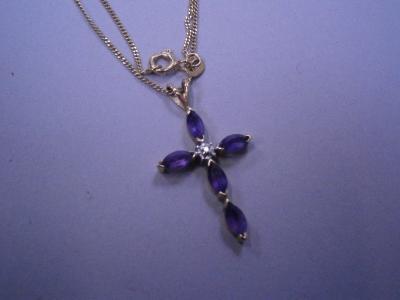A 9ct gold crucifix on chain; the crucifix with central white stone and surrounded by four amethyst