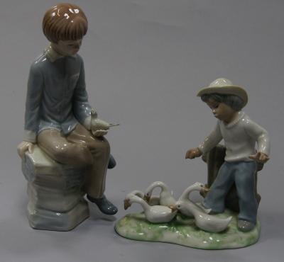 Two Lladro type Spanish figures of boys.