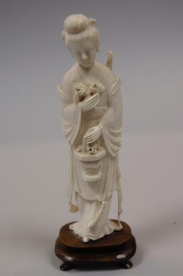 An early 20thC carved ivory figure of Guan Yin