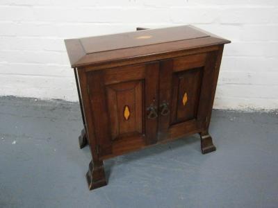 A small inlaid mahogany two door cupboard