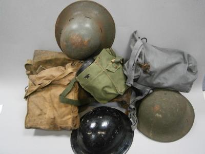 Three military gas masks and three British helmets WWII and later together with an an antique leathe