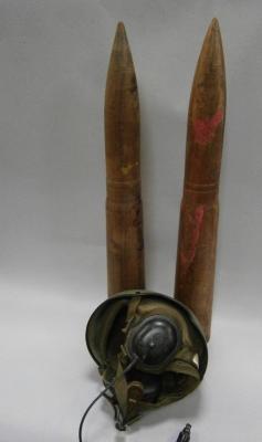 American tankers helmets and two large dummy wooden training shells.