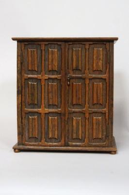 A smokers cabinet carved in the form of a linenfold double wardrobe