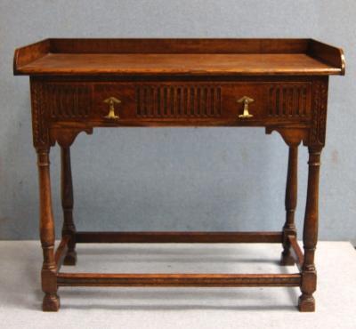 A 20thC oak side table with tray top