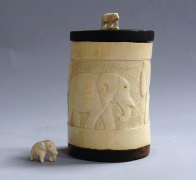 An Indian carved ivory jar and cover decorated throughout with elephants