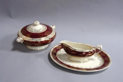 A Ducal ware gilt and maroon bordered dinner service.